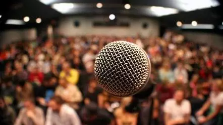 Image of microphone in crowded lecture hall